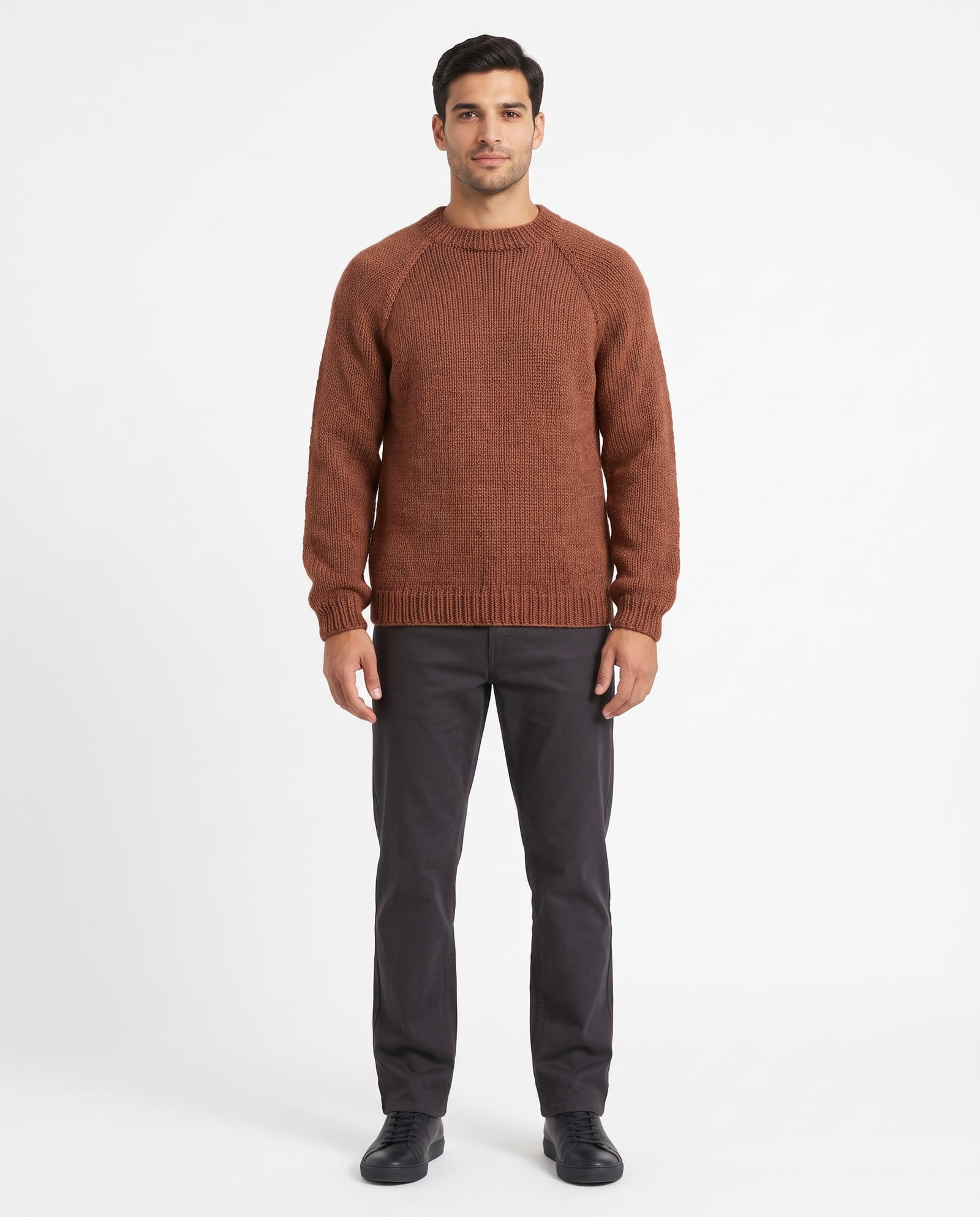 Model wearing the rust hand-knit sweater in a pure-white marketplace background