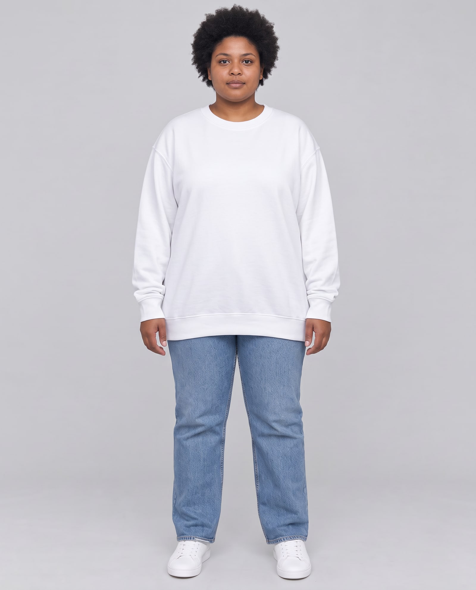 Model wearing the white crewneck sweatshirt in a light-grey studio