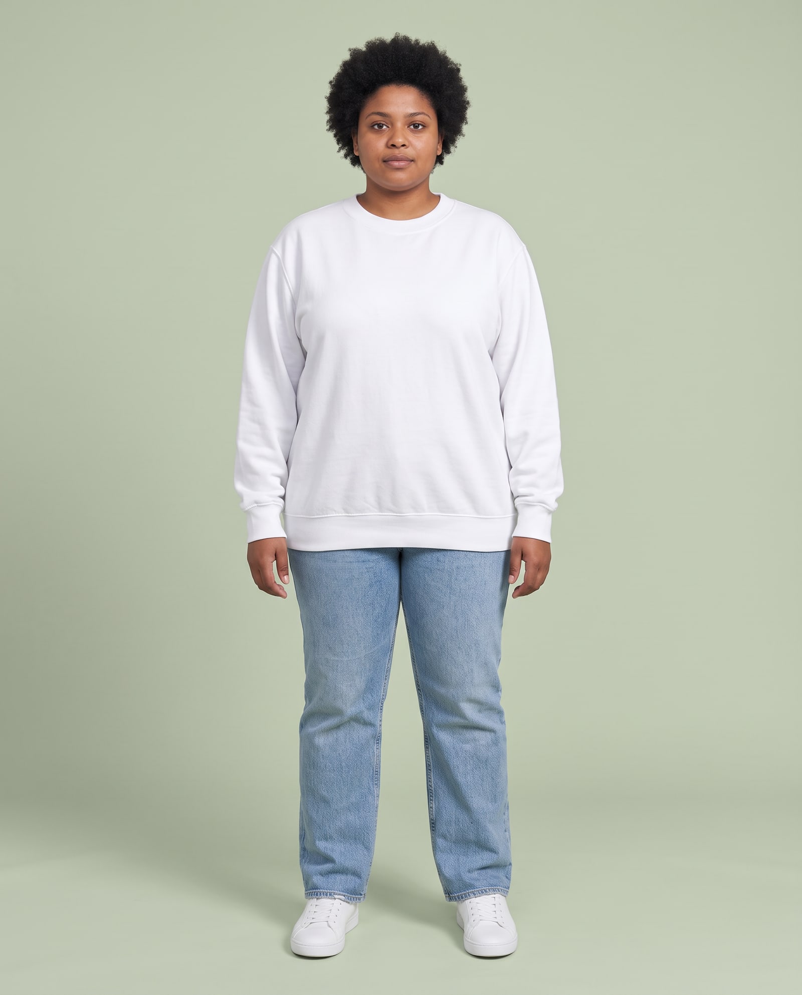 Model wearing the white crewneck sweatshirt in a pale sage studio