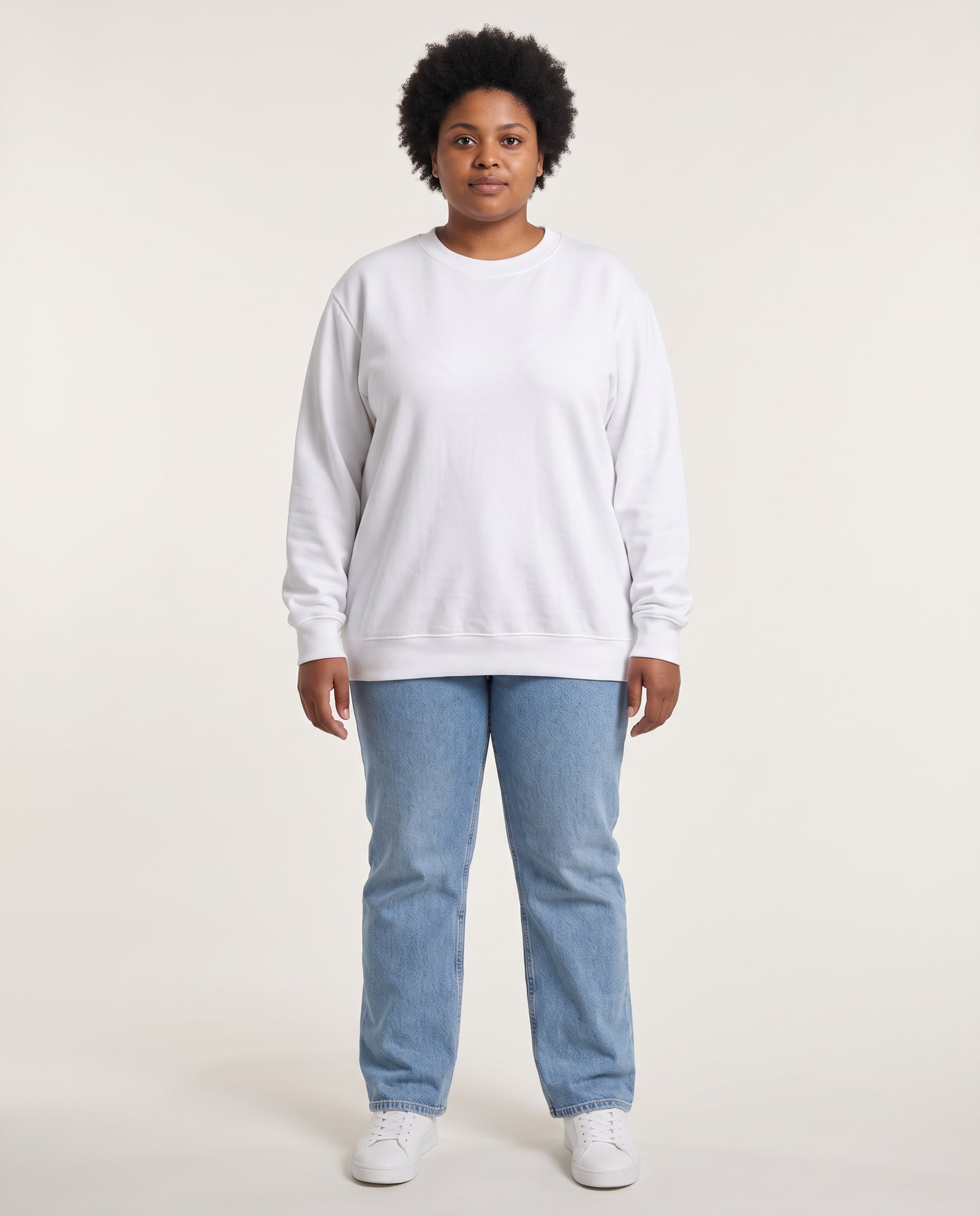 Model wearing the white crewneck sweatshirt in a soft white studio