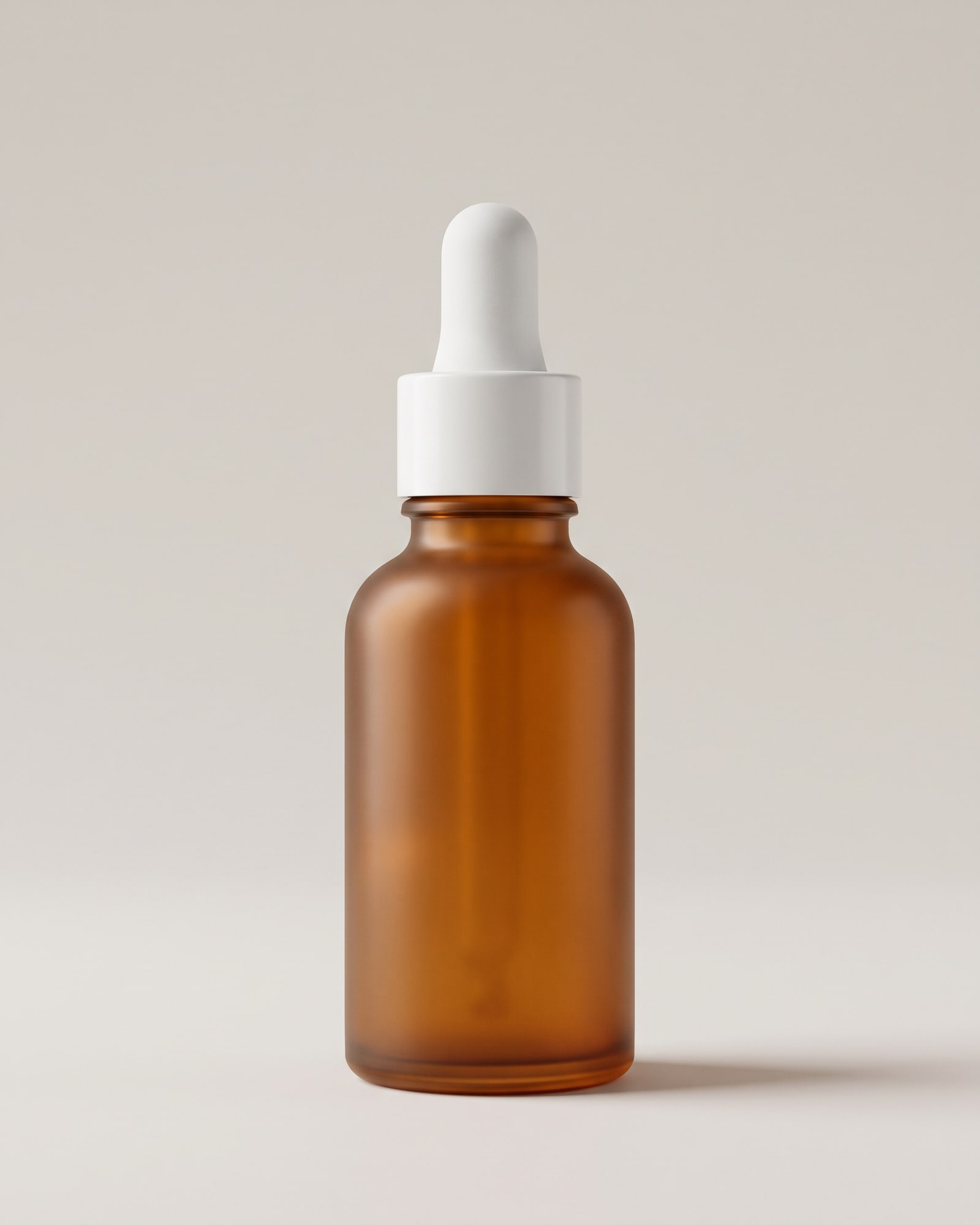 Amber glass serum bottle with a white dropper on light grey