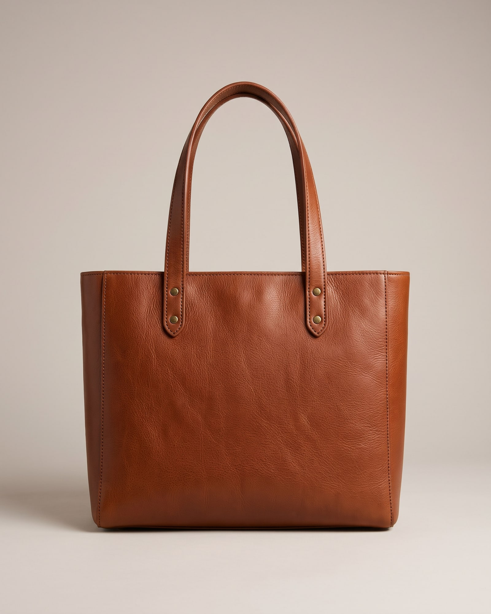 Cognac leather tote bag on light grey